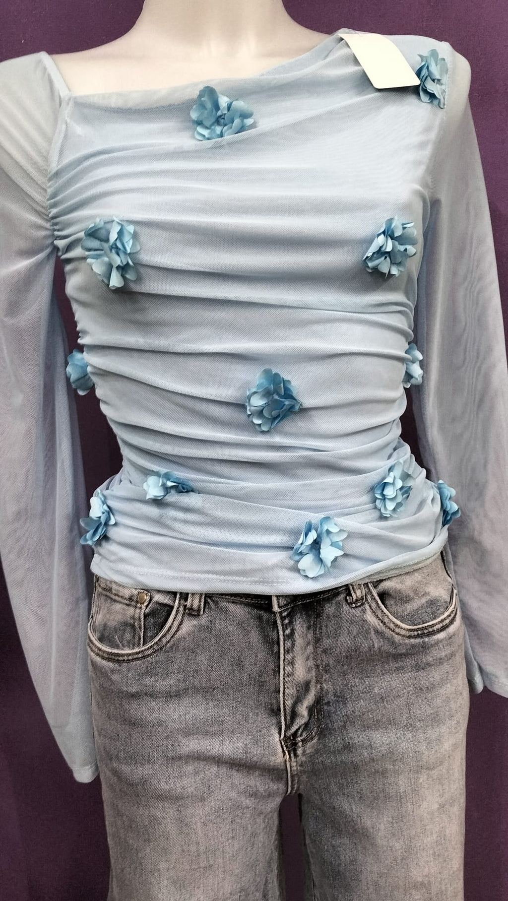 Maglietta chic ,elegante  con applicazioni  di fiorellini di stoffa, con scollo asimmetrico.